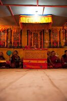 People praying at prayer hall of school, Ura valley, Bhutan