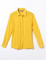 Close-up of yellow silk shirt blouse on white background