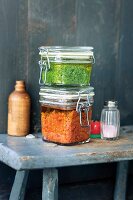 Parsley pesto and tomato pesto in flip-top jars