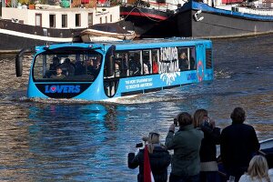 People travelling in floating bus in Oudeschans, Amsterdam, Netherlands