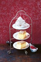 Cream slices with raspberry sauce on a cake stand