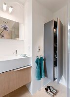 Bathroom with open vanity cupboard, spotlights and mirror