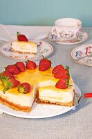 Lime cheesecake with strawberries on plate