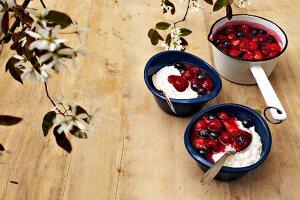 Cream and rice pudding with red fruit jelly in pot