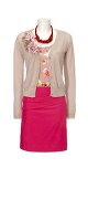 Pink skirt, floral blouse, beige cardigan and chain on mannequin against white background
