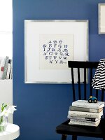 Alphabets embroidered on photo frame against blue background