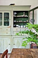 Kitchen cabinet with porcelain in Gustavian style at Gutshaus Boldevitz, Germany