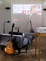 Sofa, guitar, projector screen in wall on living room