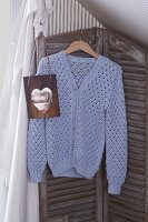 Blue lacy cardigan with buttons on hanger
