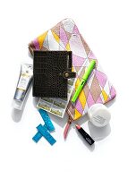 Close-up of make-up, organizer, cosmetics and pouch on white background, overhead view