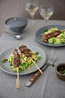 Lamb kebabs on a vegetable and bulgur salad