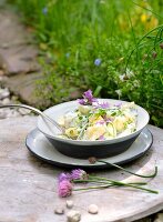 Potato salad with herbs and chive flowers