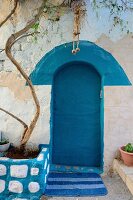 Entrance with blue door in alley at Safed, Israel