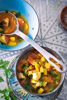 Fish soup and vegetable stew with zucchini in bowls, Bavaria, Germany