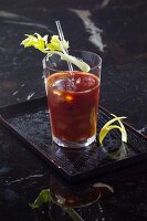 Glass of bloody mary cocktail on serving plate