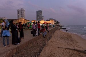 People at promenade in front of Galle Face Hotel at dusk, Colombo, Sri Lanka