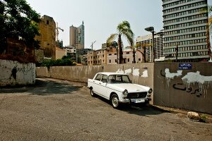 White car parked in front of wall in Beirut, Lebanon
