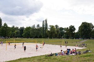 People playing beach volleyball at Friedrichshain Public Park in Berlin, Germany