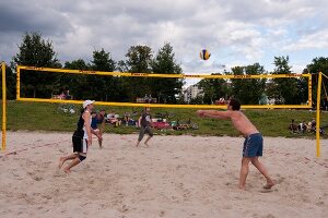 People playing beach volleyball at Friedrichshain Public Park in Berlin, Germany