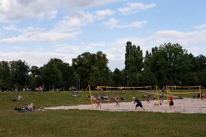 People playing beach volleyball at Friedrichshain Public Park in Berlin, Germany