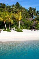 Bungalow resort on beach of island Veligandu Huraa, Maldives