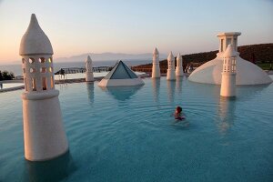 Man swimming in pool of Kempinski Hotel Barbaros Bay in Aegean, Turkey