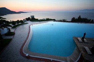 Man swimming in pool of Kempinski Hotel Barbaros Bay in Aegean, Turkey