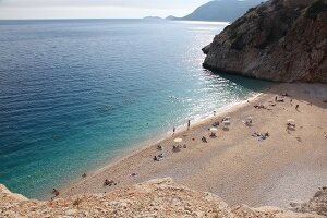 People and two ships at Kaputas beach in Turkey