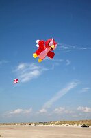 Multi-coloured flags in sky on kite festival at Fano beach, Denmark