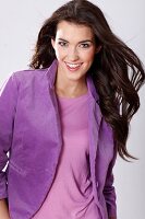 Portrait of beautiful woman with dark long hair wearing purple blazer, smiling