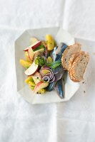 Herring with potato and tarragon salad on serving dish