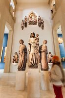 Children looking at sculptures of prophets in Munster at sculpture hall, Freiburg, Germany