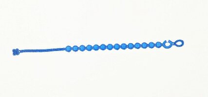 Close-up of blue friendship bracelet with small pearls on white background