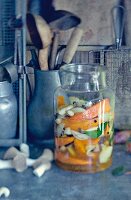 Pumpkins and mushrooms in a vinegar broth in a preserving jar