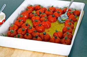 Baked cherry tomatoes with olive oil in baking dish