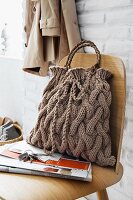 A knitted handbag with a braided pattern