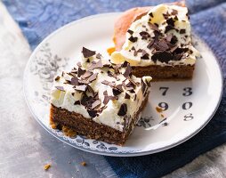 Slices of nougat tray bake cake topped with cream