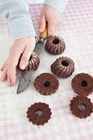 Mini Black Forest gateaux Bundt cakes being made: chocolate cakes being cut in half horizontally