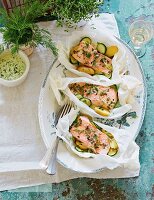 Salmon fillet with courgettes and herbs in parchment paper