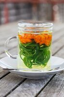 Herbal tea with marigold and verbena in a tea glass