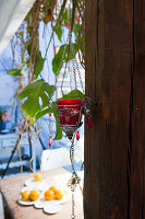 Hanging candlestick, dining table set behind it