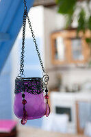 Purple glass lantern with metal chain and pearl decorations