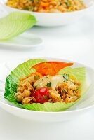 Rice salad with onions and peppers in a lettuce leaf