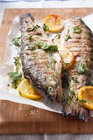Two grilled trout with lemon and herbs