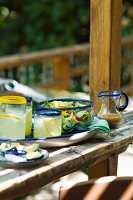 Glasses of Lemonade and Salad in a Glass Bowl on Outdoor Patio Table