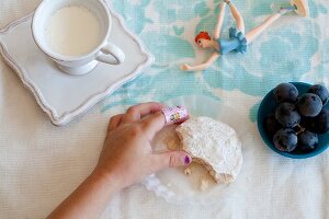 Little Girl's Hand Grabbing Cookie; Glass of Milk; Toy