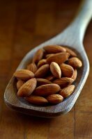 Whole Almonds in a Wooden Spoon