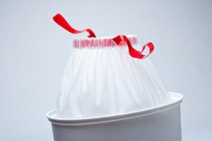 White Drawstring Garbage Bag in a Trash Can