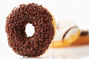 A doughnut with chocolate glaze and chocolate sprinkles