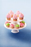 Cupcakes decorated with buttercream and sugar crystals on a cake stand